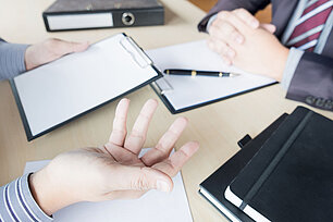 Businessman conducting an interview with businessman in an offic HSKL
