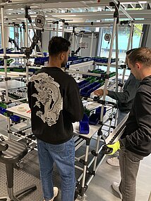 zwei Studierende entwickeln einen Montagearbeitsplatz
