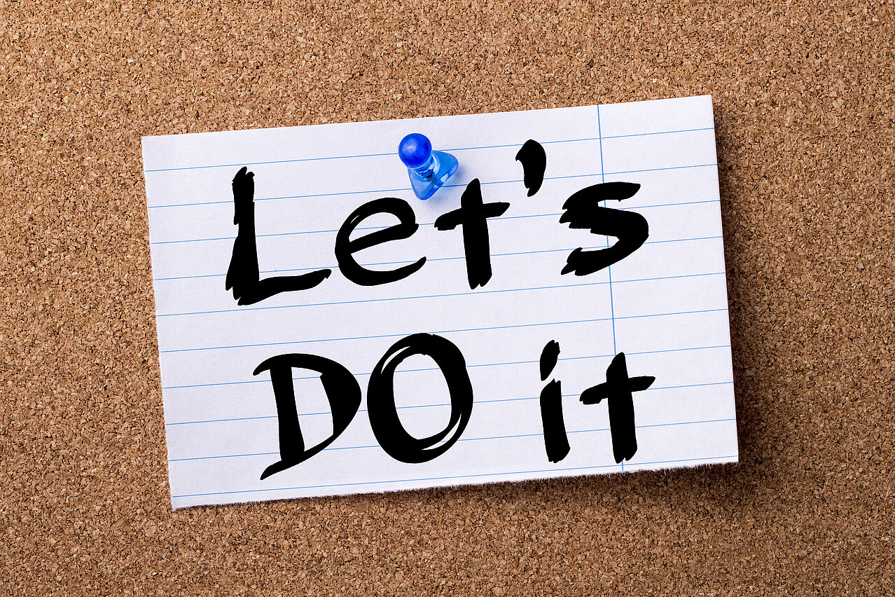 Let’s DO it - teared note paper pinned on bulletin board